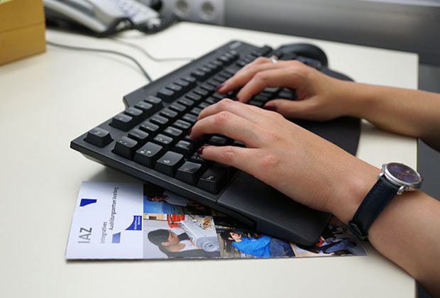 Zwei Hände auf einer PC-Tastatur. 